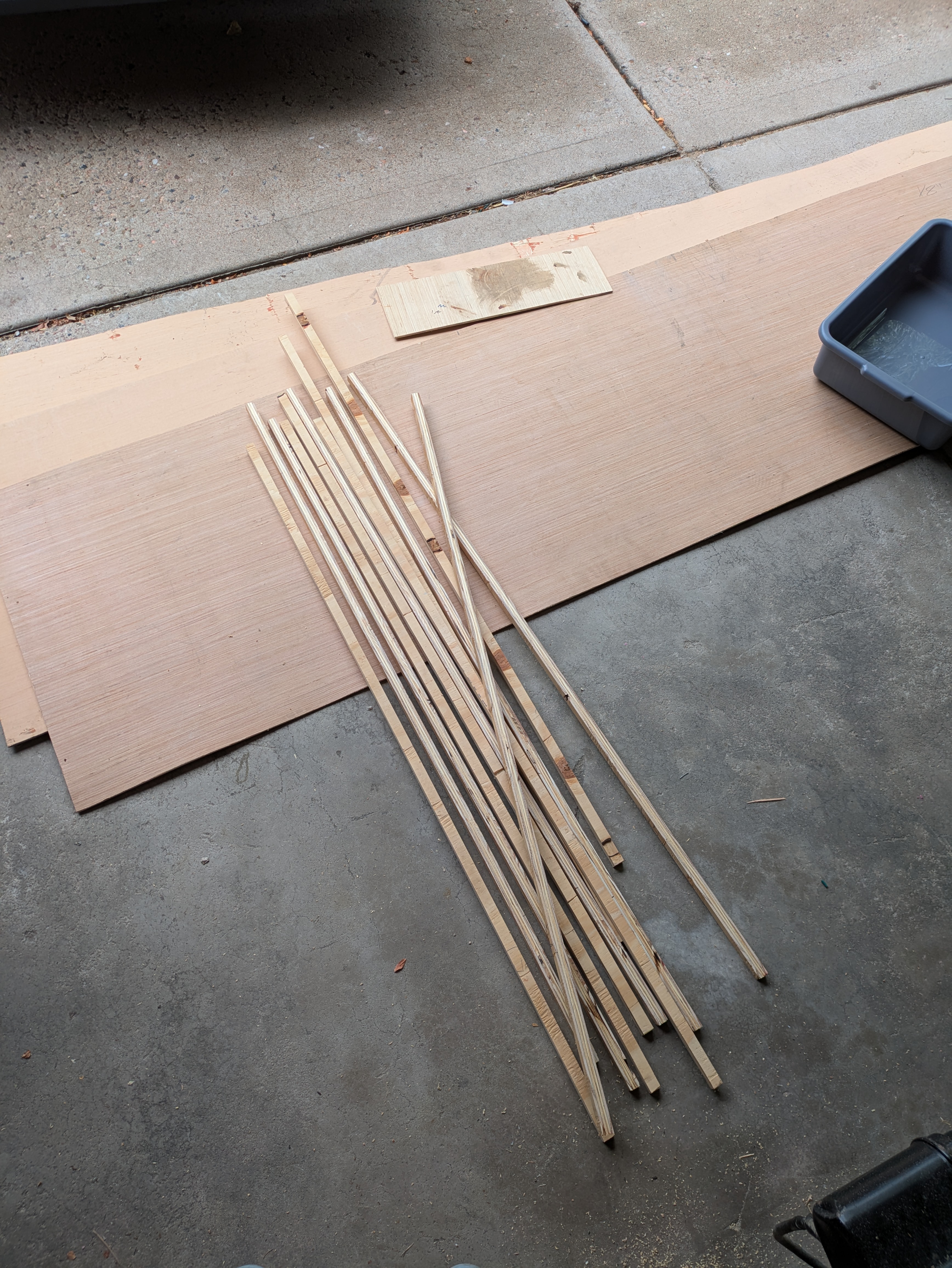 A pile of strips of cut plywood.