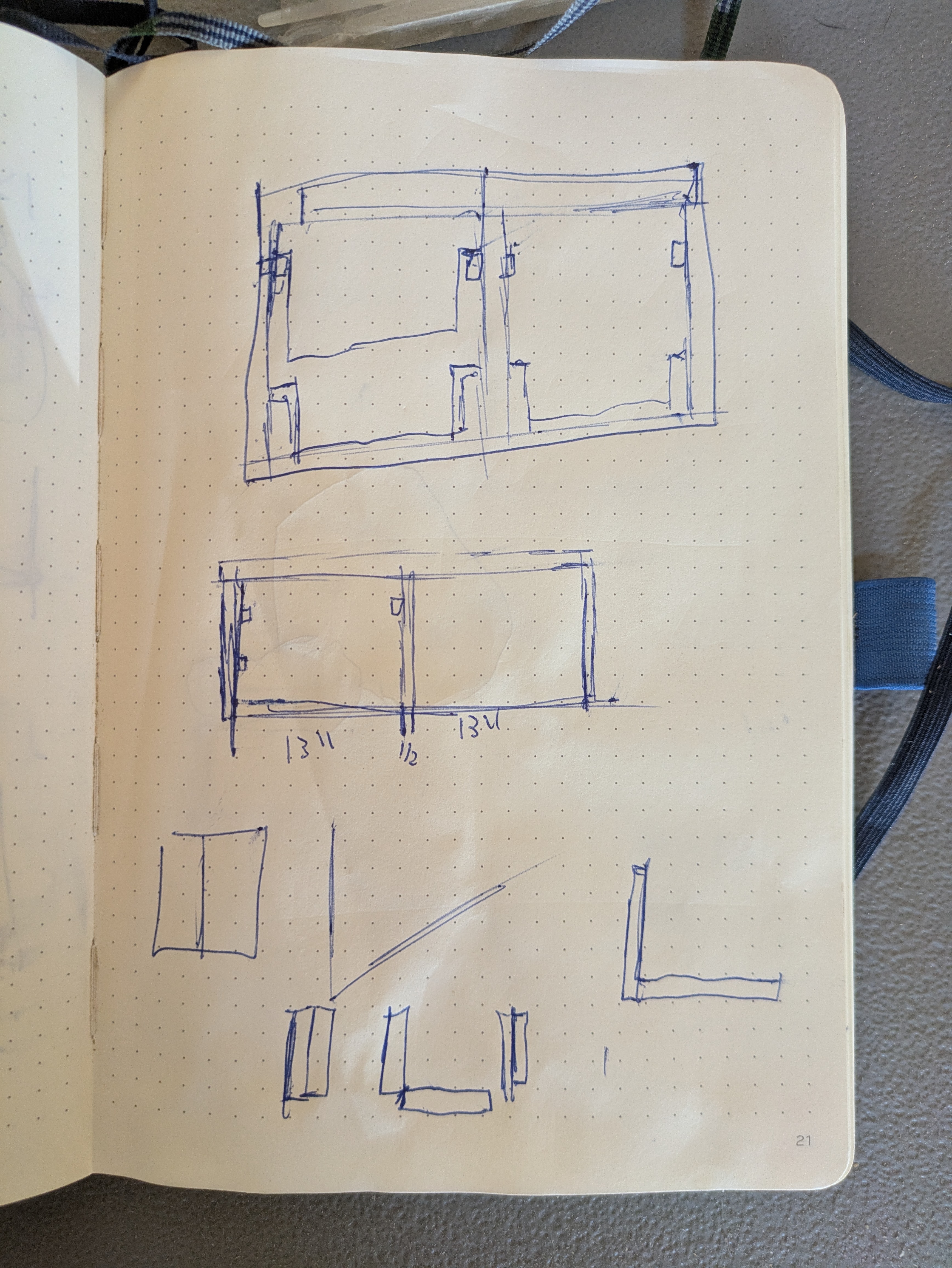 Internal view drawings of the chuck box plans in a dot grid notebook showing the rails for the storage bins.